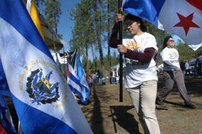 
Erika Ramirez, 18, places the Panamanian flag into a stand Saturday during opening ceremonies of Hispanic Heritage Celebration 2007  in Riverside State Park. 
 (Dan Pelle / The Spokesman-Review)