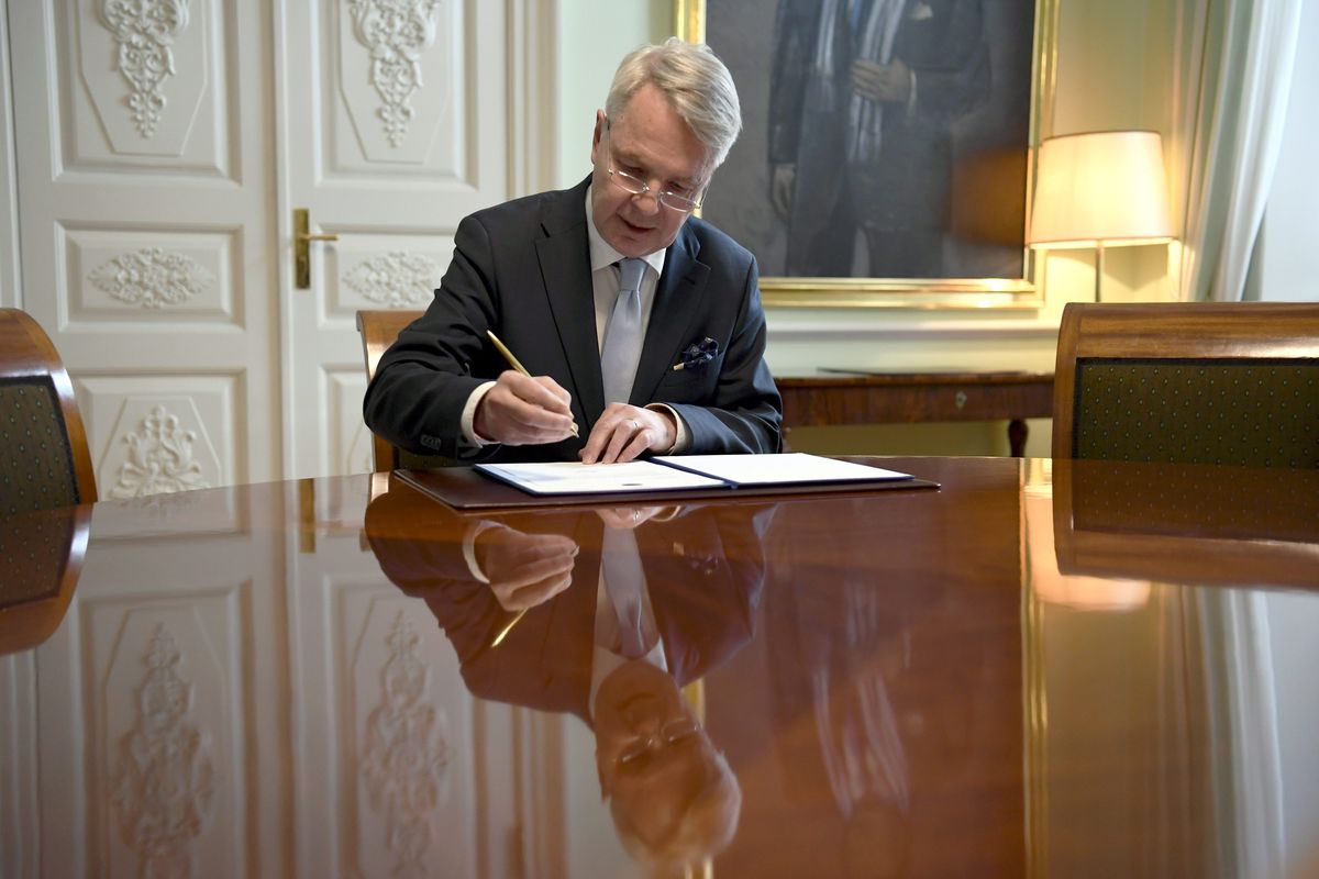 Finnish Foreign Minister Pekka Haavisto signs a petition for NATO membership application in Helsinki, Tuesday, May 17, 2022. Sweden and Finland on Tuesday pushed ahead with their bids to join NATO even as Turkey insisted it won’t let the previously non-aligned Nordic countries into the alliance because of their alleged support for Kurdish militants.  (Antti Aimo-Koivisto)