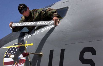 
Col. Tony Mauer's name is removed and Col. Scott Hanson's name is revealed on a C-135 refueler on Thursday during the 92nd Air Refueling Wing Change of Command. 
 (Jed Conklin / The Spokesman-Review)