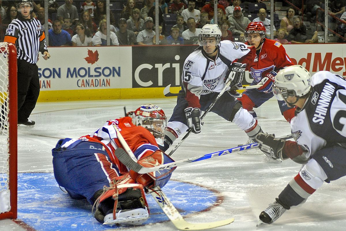 Spokane Chiefs goalie  James Reid kicks out to his right to block a shot by Tri-Cities American Brendan Shinnimin during the first period on Saturday night.  (Christopher Anderson / The Spokesman-Review)