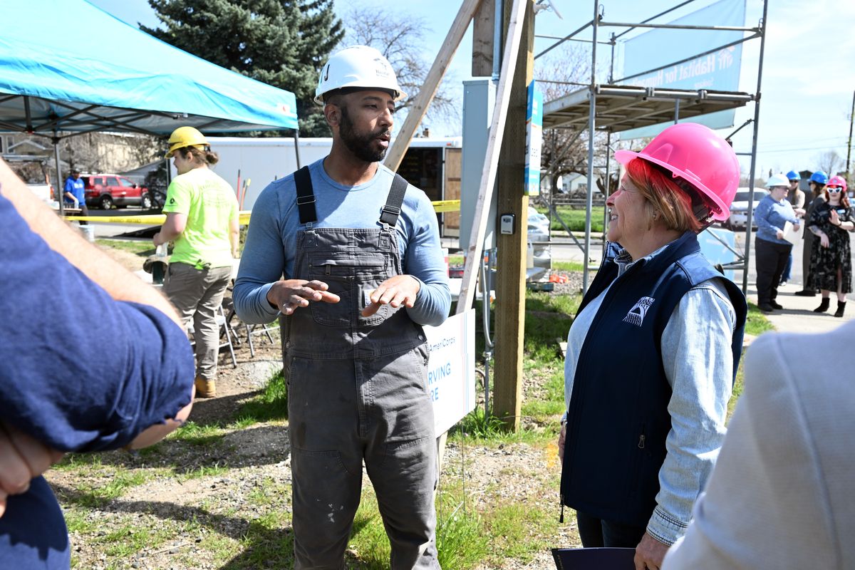 Spokane Mayor Lisa Brown, right, talks with J.J. Jones, left, a construction supervisor for Habitat for Humanity at a home in East Spokane where she appeared to mark the Mayor