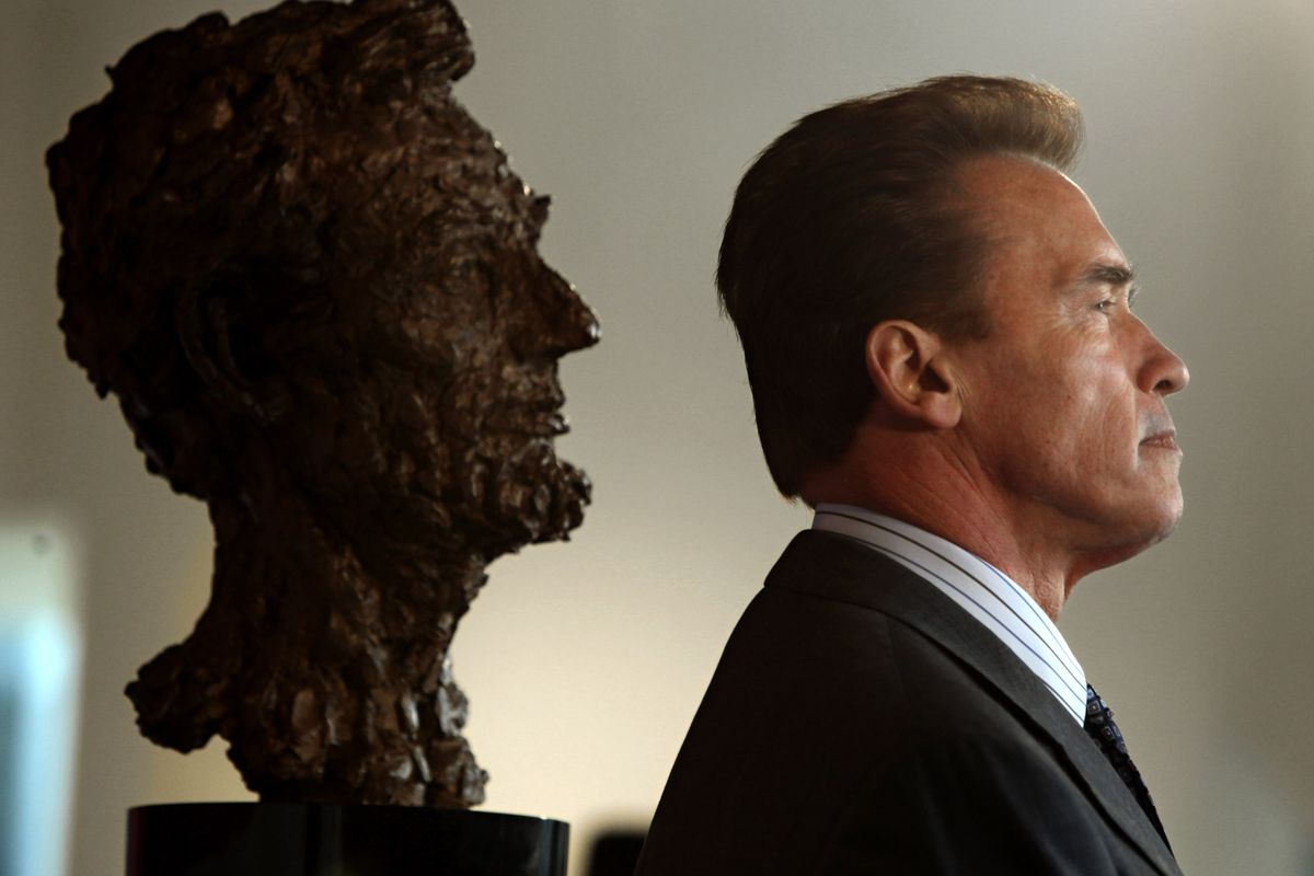 FILE - In this Feb 11, 2009 file photo, former Gov. Arnold Schwarzenegger and a bust of Abraham Lincoln are seen in profile during a celebration of Lincoln