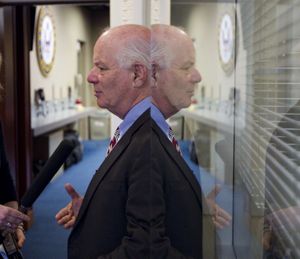 Sen. Ben Cardin, D-Md. is reflected in a window on Capitol Hill in Washington, Monday, Feb. 22, 2010, as he answers reporters questions following a news conference to discuss the upcoming jobs bill. (Alex Brandon / Associated Press)