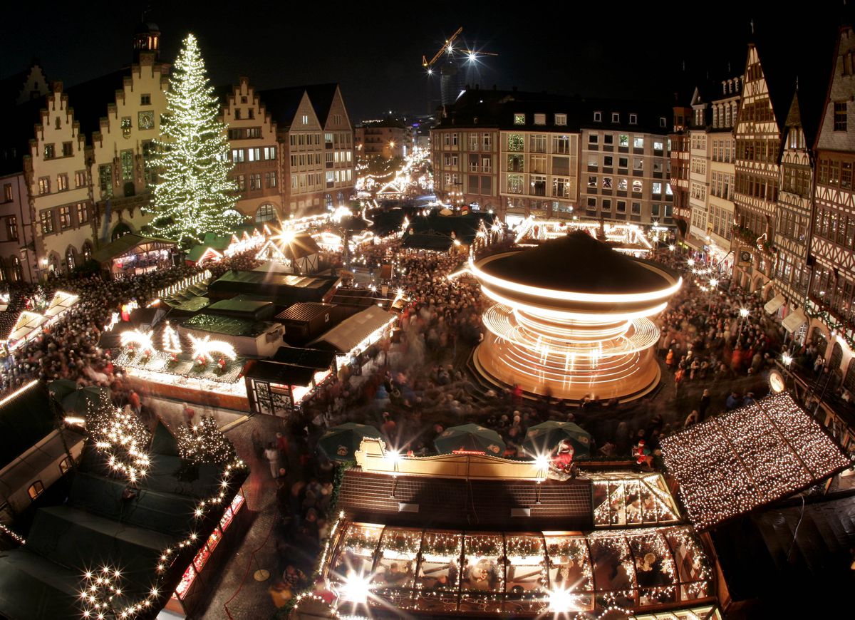 Hundreds of people gather around a merry go round at the traditional Christmas market in Frankfurt, central Germany that opened on Nov. 26. (Associated Press / The Spokesman-Review)