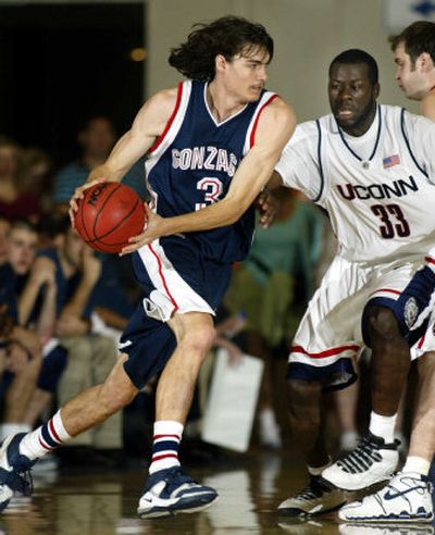 Gonzaga's Adam Morrison, left, drives past Connecticut's Denham Brown. 
 (Associated Press / The Spokesman-Review)