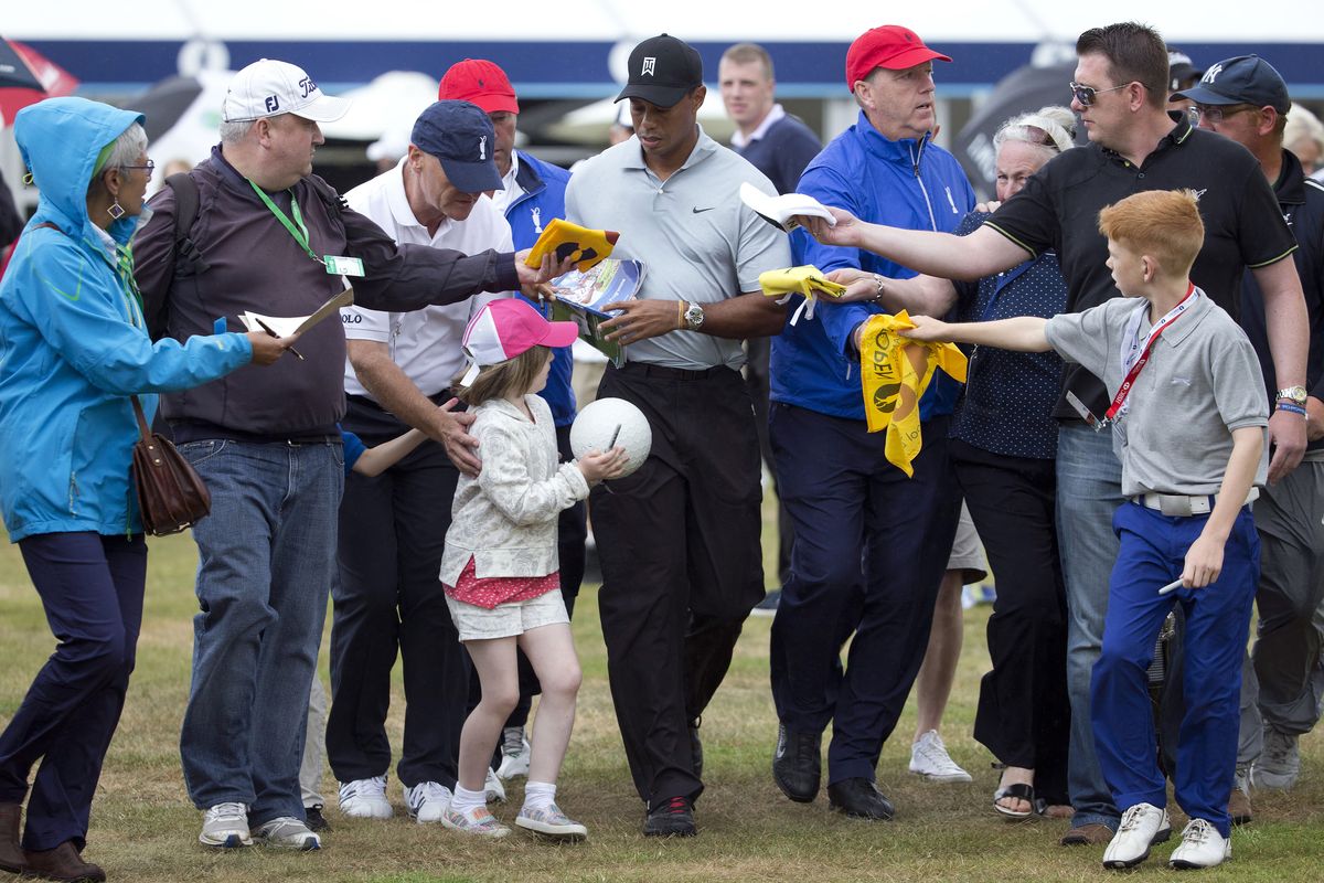 Tiger Woods, signing autographs as he leaves the practice green Wednesday, won the 2006 British Open at Hoylake. (Associated Press)