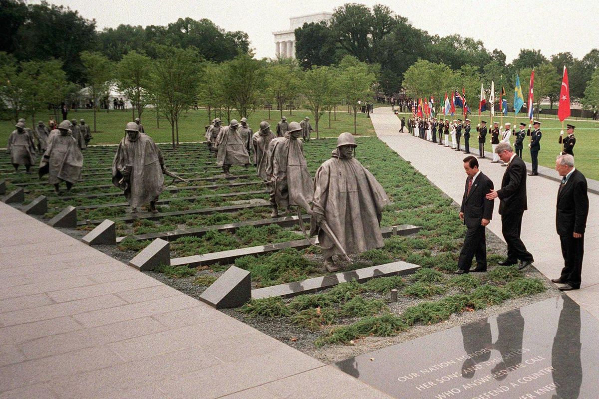 President Bill Clinton, (center) South Korean President Kim Young Sam, left, and Congressional Medal of Honor recipient Gen. Raymond Davis walk towards one of the 19 statues comprising the Korean War Memorial during its dedication on July 27, 1995  in Washington. Constructed of 19 statues, a reflecting pool and historic photographs, the memorial pays tribute to the 1.5 million Americans who fought in the Korean War. The memorial was dedicated on July 27, the anniversary of the armistice agreement which brought the war to an end in 1953. (CHUCK KENNEDY / KRT)