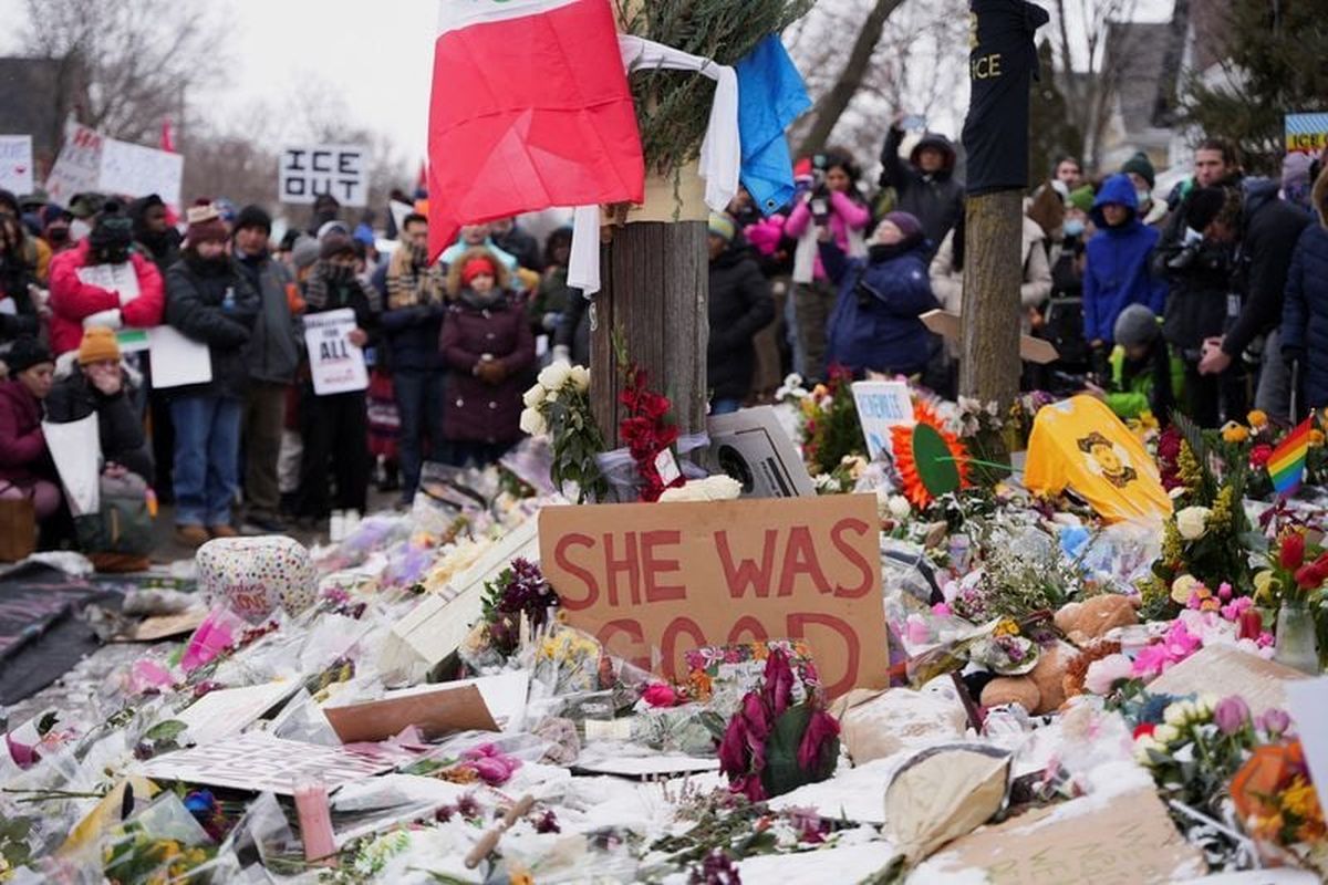 People stand before a makeshift memorial during an “ICE Out of Minnesota” rally and march organized by MIRAC (Minnesota Immigrant Rights Action Committee), days after the fatal shooting of Renee Nicole Good by an ICE agent Saturday, in Minneapolis.  (Reuters)