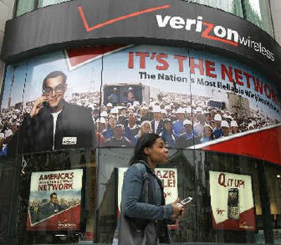 
A woman walks past a Verizon Wireless store in San Francisco on Monday. 
 (Associated Press / The Spokesman-Review)