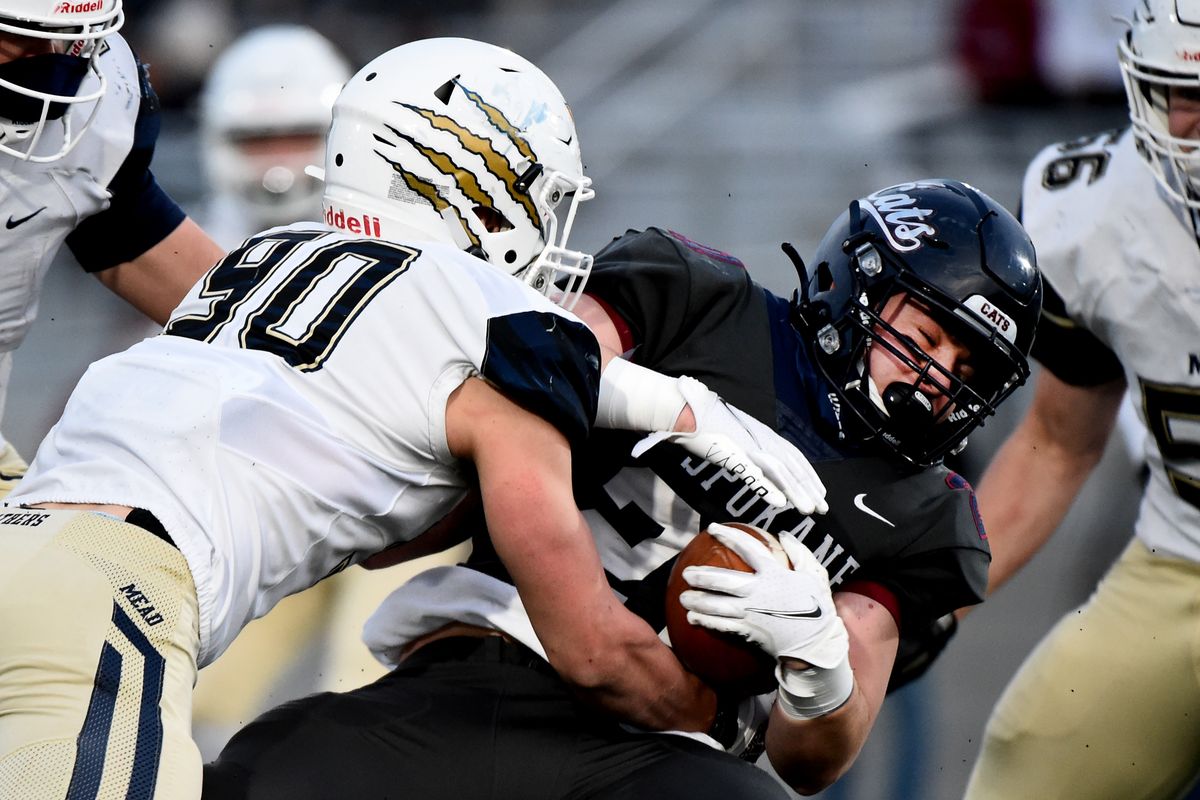 Mead lineman Riley Ayala, left, stops Mt. Spokane fullback Hudson Gilbert before the line of scrimmage during the Wildcats’ Greater Spokane League win Friday at Union Stadium in Spokane.  (James Snook/For The Spokesman-Review)