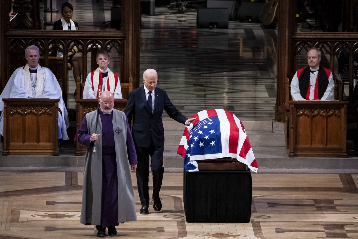 President Joe Biden touches the casket after delivering remarks at the state funeral of former President Jimmy Carter on Thursday at Washington National Cathedral in Washington, D.C. President Joe Biden declared Thursday a national day of mourning for Carter, the 39th president of the United States, who died at the age of 100 on Dec. 29 at his home in Plains, Ga.  (Pool)