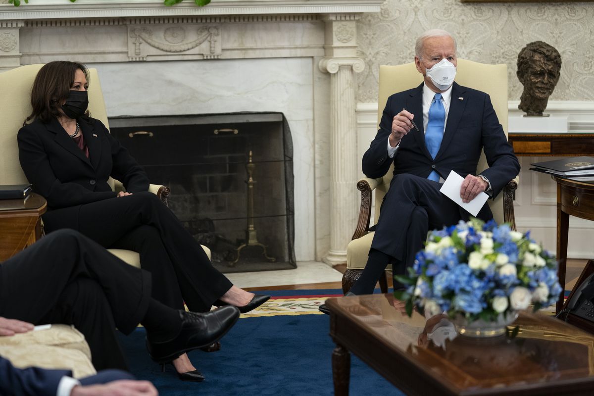 Vice President Kamala Harris listens as President Joe Biden speaks during a meeting with a bipartisan group of mayors and governors to discuss a coronavirus relief package, in the Oval Office of the White House, Friday, Feb. 12, 2021, in Washington.  (Evan Vucci)