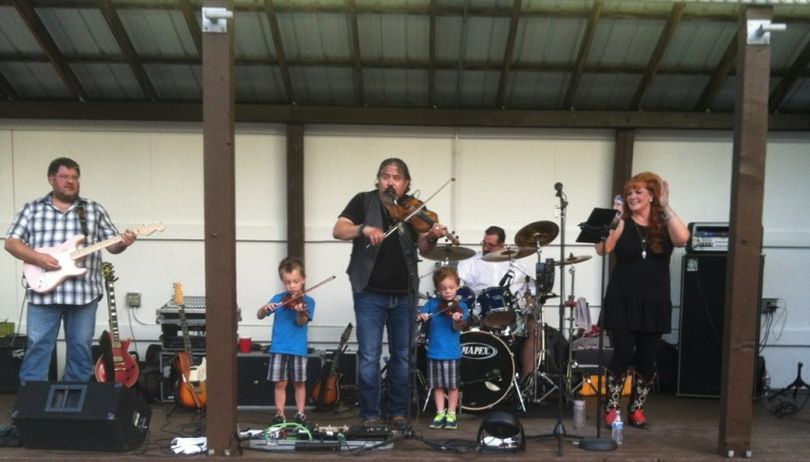 Fiddler Keith Niehenke and his wife Julie Layne were joined on stage by their twin boys for one song by Keith and the Hankers during the Handshake Productions concert at Hayden City Park. (Chris Guggemos / Handshake Productions)