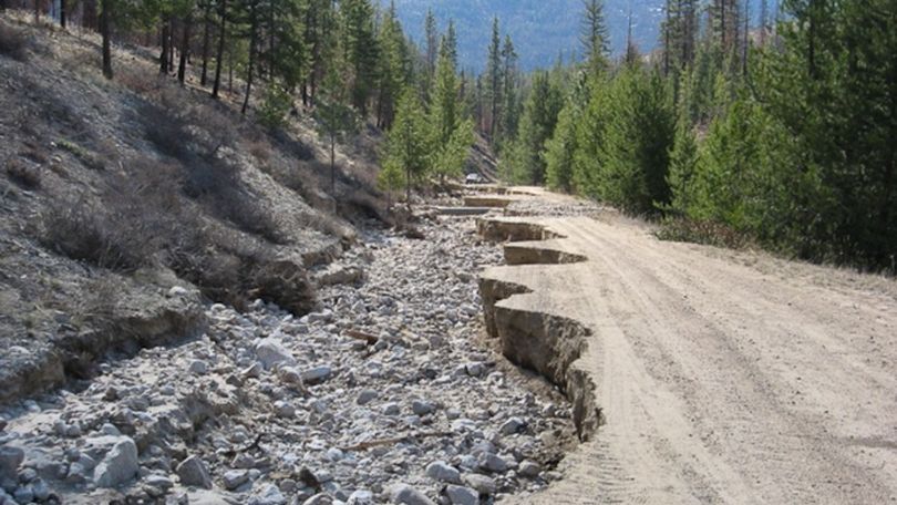 A plugged culvert diverted streamflow onto this forest road in the Okanogan-Wenatchee National Forest. Legacy Roads and Trails Program funding paid to decommission the high-risk area in this photo, according to Northwest Public Radio. The remaining road was rerouted. (U.S. Forest Service, Region 6)