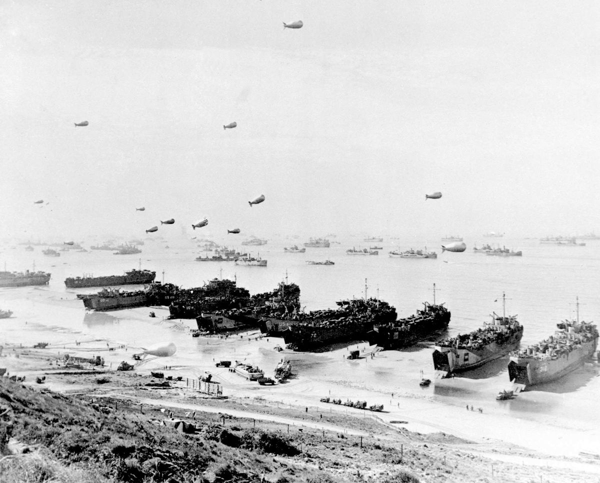 FILE-This was the scene along a section of Omaha Beach in June, 1944 during Operation Overlord, the code name for the Normandy invasion during World War II. Large landing craft put troops and supplies on shore at Omaha, one of five invasion beaches. In background is part of the fleet of 2,727 ships that brought the allied troops from Britain. In the air are barrage balloons, designed to entangle low-flying attack aircraft in their cables. (AP Photo/files)  (Associated Press)