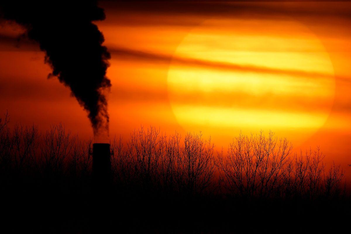 CORRECTS CITY TO KANSAS CITY FROM INDEPENDENCE - FILE - Emissions from a coal-fired power plant are silhouetted against the setting sun, Monday, Feb. 1, 2021, in Kansas City, Mo.  (Charlie Riedel)