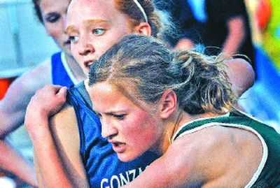 
Shadle Park's Andrea Nelson, right, winner of the girls 1,600 meters, falls into the arms of second-place Theresa Hailey of G-Prep.  
 (Jed Conklin / The Spokesman-Review)