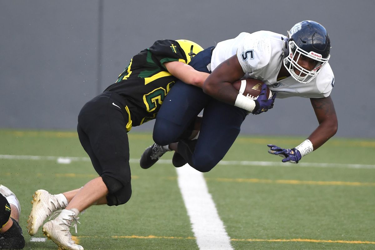 Shadle Park’s Justin Stevens, left, can’t keep Gonzaga Prep’s Devin Culp from diving into the end zone Friday, Sept. 29, 2017 at Joe Albi Stadium. The Bullpups ended the first half of the GSL matchup 35-7 over the Highlanders. This play made it 14-7. (Jesse Tinsley / The Spokesman-Review)