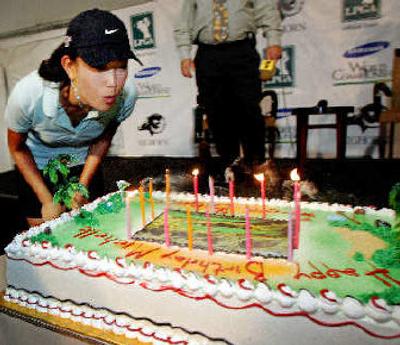 
Michelle Wie celebrates her 16th birthday Tuesday with a cake at Bighorn Golf Club. 
 (Associated Press / The Spokesman-Review)