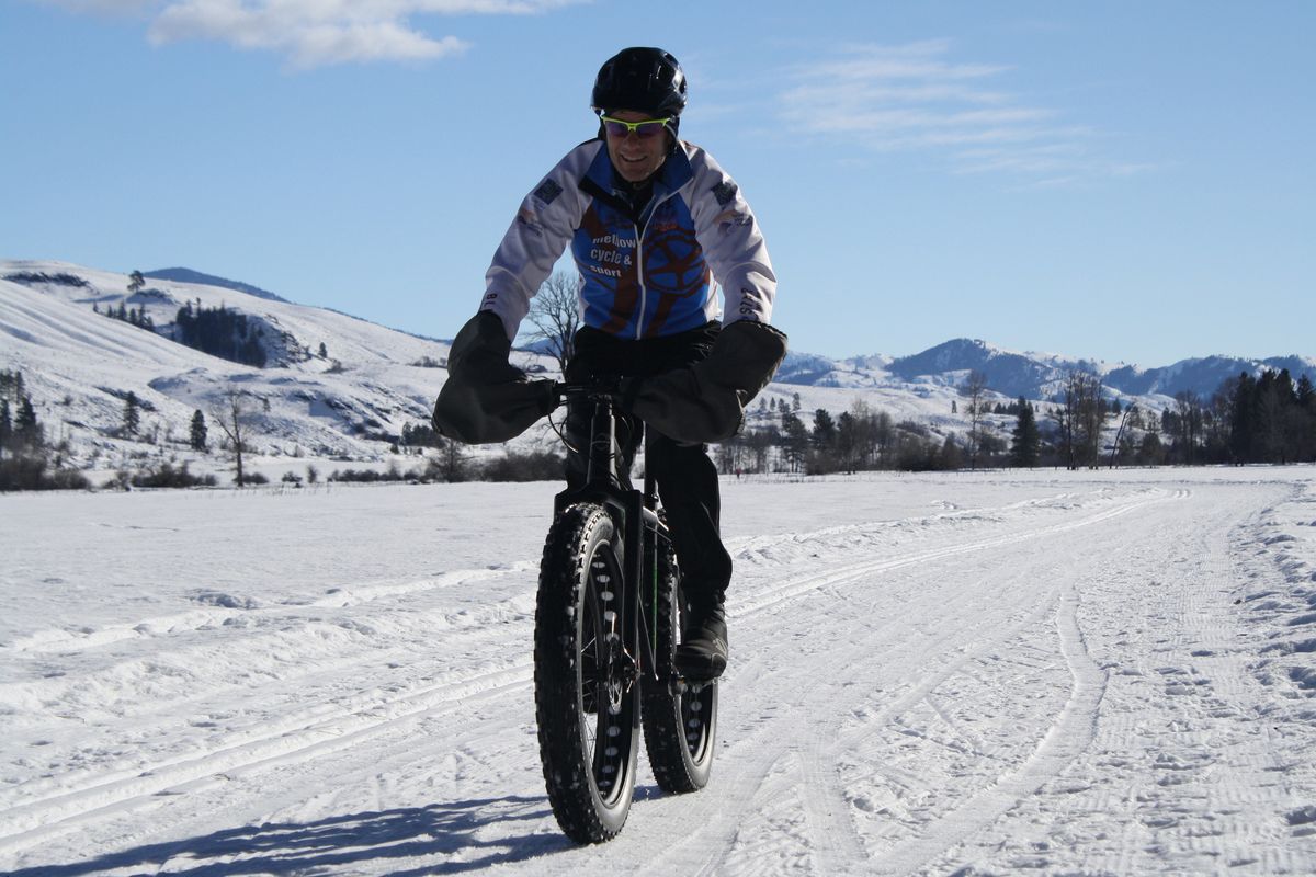 Joe Brown rides a fat bike through Big Valley near Winthrop, where snow biking is being tested as the latest addition to the winter sports trails scene. (Associated Press)