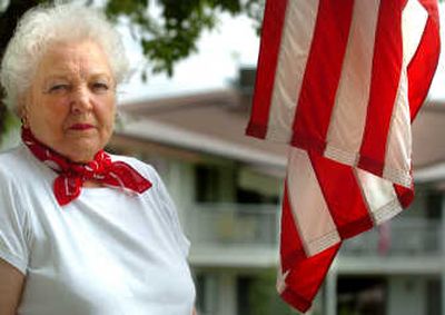 
Ilabelle Alderson poses for a portrait next to an American flag  in front of her residence at the Holman Gardens.
 (Ingrid Lindemann / The Spokesman-Review)