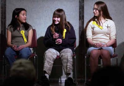 
Horizon eighth-grader Cindy Wu, left, and North Pines eighth-grader Angela Meter, right, watch as Mountain View  sixth-grader Melissa Kersh, middle, spells the word 