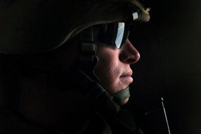 Undivided attention: Sunlight pierces a tiny bulletproof glass window, through which Cpl. Matthew Shipp, of India Battery of the 3rd Battalion, 11th Marine Regiment, keeps a watchful eye. His  Mine Resistant Ambush Protected vehicle (MRAP) was patrolling the streets of Rutbah in western Iraq.
 (The Spokesman-Review)