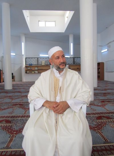Sheikh Abdul Razak Msherab’s mosque issues unofficial gun permits for the weapons that have proliferated since the uprising against Moammar Gadhafi.