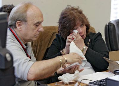 Maureen Santora wipes her eyes as her husband, Al Santora, sorts through compact discs of emergency calls on Sept. 11, 2001, that were released in New York on Friday.
(Associated Press / The Spokesman-Review)