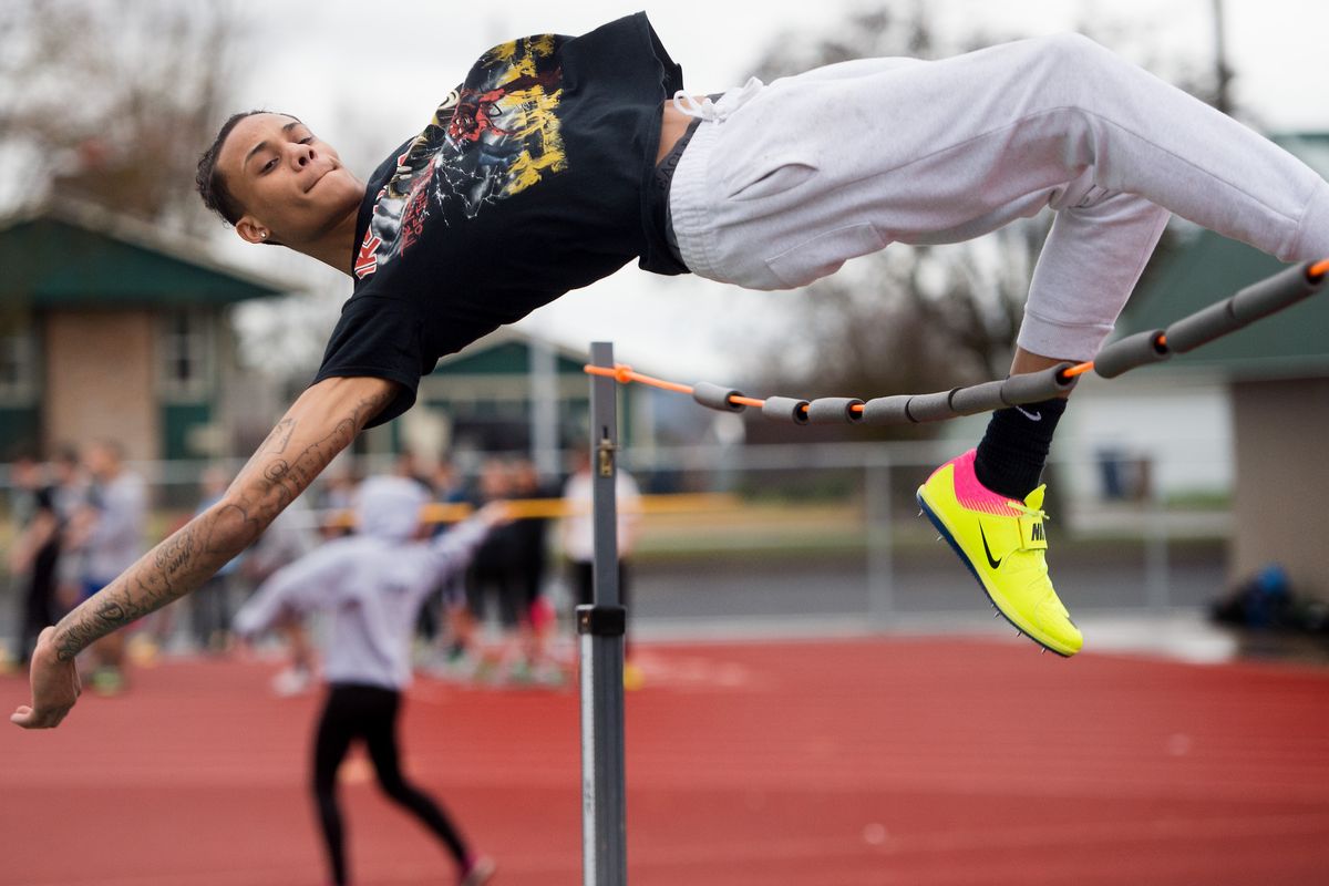 Shadle Park’s Jakobe Ford gracefully leaps over a training bar in March 2017 at Shadle Park High School in Spokane. (TYLER TJOMSLAND)