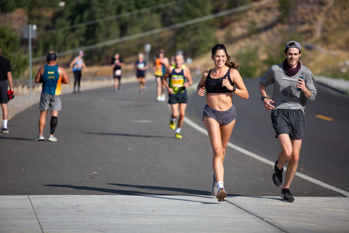 Bri Vasquez and Brandon Pollard conquered Doomsday Hill and continue on during the Virtual Bloomsday race on Sept. 20 in Spokane. (Libby Kamrowski/ THE SPOKESMAN-REVIEW)