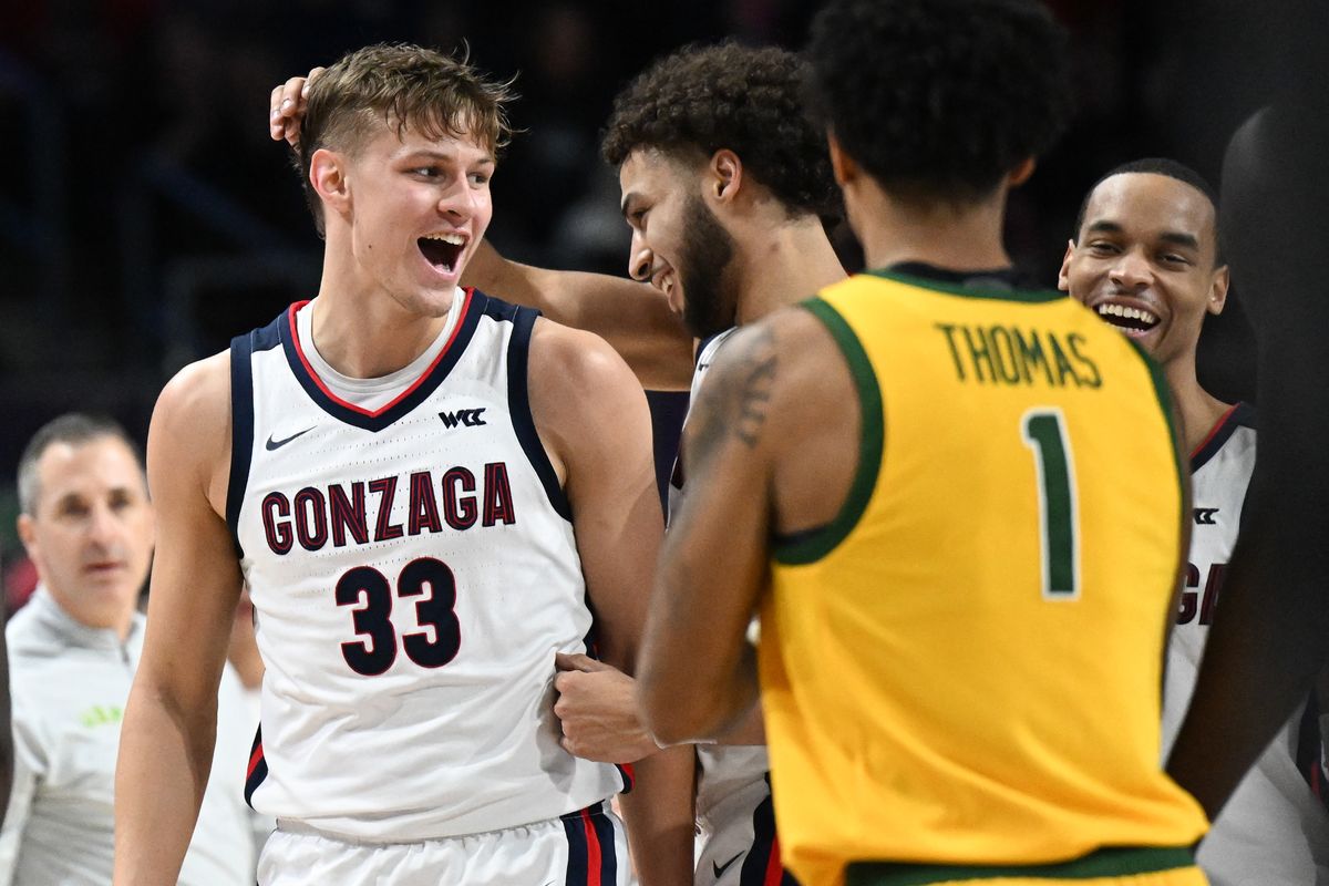 Gonzaga Bulldogs forward Anton Watson (22) rubs the head of forward Ben Gregg (33) as guard Nolan Hickman (11) smiles after Gregg hit a three against the San Francisco Dons as Dons head coach Chris Gerlufsen, left, and guard Malik Thomas (1) react during the second half of a WCC men’s semifinal basketball game on Monday, Mar 11, 2024, at Orleans Arena in Las Vegas, Nev. Gonzaga won the game 89-77.  (Tyler Tjomsland/The Spokesman-Review)