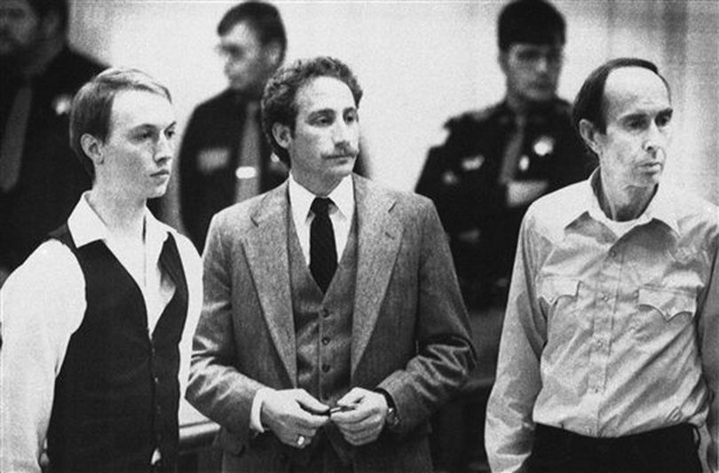 This Dec. 18, 1984 file photo shows Don Nichols, right, standing with his son, Dan Nichols, left, as they pled not guilty in court in Virginia City, Mont. Standing with them is attorney, Steve Ungar. The U.S. attorney’s office in Montana has filed federal drug and weapons charges against Dan Nichols, part of the father and-son duo convicted in kidnapping a world class athlete in 1984, killing a would-be rescuer and eluding authorities for months, April 19, 2012. ((AP Photo/File))