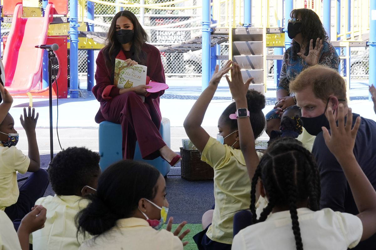 Meghan, the Duchess of Sussex, fields questions from students after she read from her book “The Bench,” with Prince Harry, right, during their visit to P.S. 123, the Mahalia Jackson School, in New York’s Harlem neighborhood, Friday, Sept. 24, 2021. Seated background right is Principal Melitina Hernandez,  (Richard Drew)
