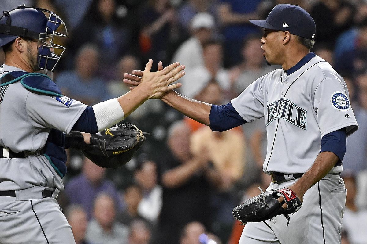 Seattle Mariners relief pitcher Edwin Diaz, right, clasps hands with catcher Mike Zunino after striking out Houston Astros’ Norichika Aoki to end a baseball game, Thursday, April 6, 2017, in Houston. Seattle won 4-2. (Eric Christian Smith / Associated Press)