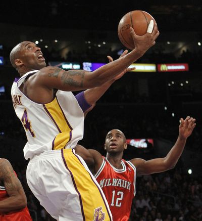 Lakers guard Kobe Bryant, left, goes to the basket as Bucks forward Luc Richard Mbah a Moute looks on.  (Associated Press)