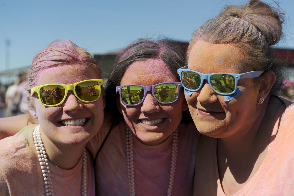 From left, Melissa Vincent, Drisana Sprat and Desiree Lesperance of Spokane display color-dusted faces after the Color Me Rad Run Saturday.