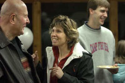 
Tracy Taitch, center, visits with George Nachtsheim during a gathering at Camp Dart-Lo. Taitch has stepped down as director of the camp and will be replaced by Bert Whitaker, right. 
 (Dan Pelle / The Spokesman-Review)