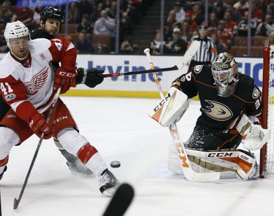 Detroit Red Wings center Luke Glendening (41) deflects a shot heading for Anaheim Ducks goalie John Gibson (36), with defenseman Brendan Smith, second from left, defending during the first period of an NHL hockey game in Anaheim, Calif., Wednesday, Jan. 4, 2017. (Alex Gallardo / Associated Press)