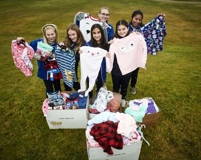 The St. Mary’s Catholic School student council members, from  left, back row, Kenedie Witherow and Emelia Tilleman; and, front, Beth Olstad,  Hadassah D.,  Olivia Wehr and Grace Dierks, have organized a pajama drive for the Christmas Bureau. (Colin Mulvany / The Spokesman-Review)