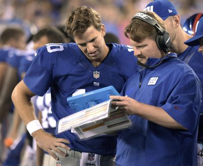 In this file photo, New York Giants offensive coordinator Ben McAdoo confers with quarterbacks Eli Manning, left, and Ryan Nassib, right, during the first half of a preseason NFL football game in East Rutherford, N.J. A person familiar with the decision tells The Associated Press the Giants are hiring offensive coordinator Ben McAdoo as their next head coach. McAdoo, 38, is being given the job a little more than a week after Tom Coughlin stepped down after 12 seasons.