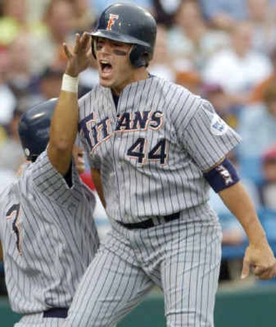 
Cal State Fullerton's P.J. Pilittere, (44), celebrates with Kurt Suzuki after both scored in the first inning against Texas.
 (Associated Press / The Spokesman-Review)