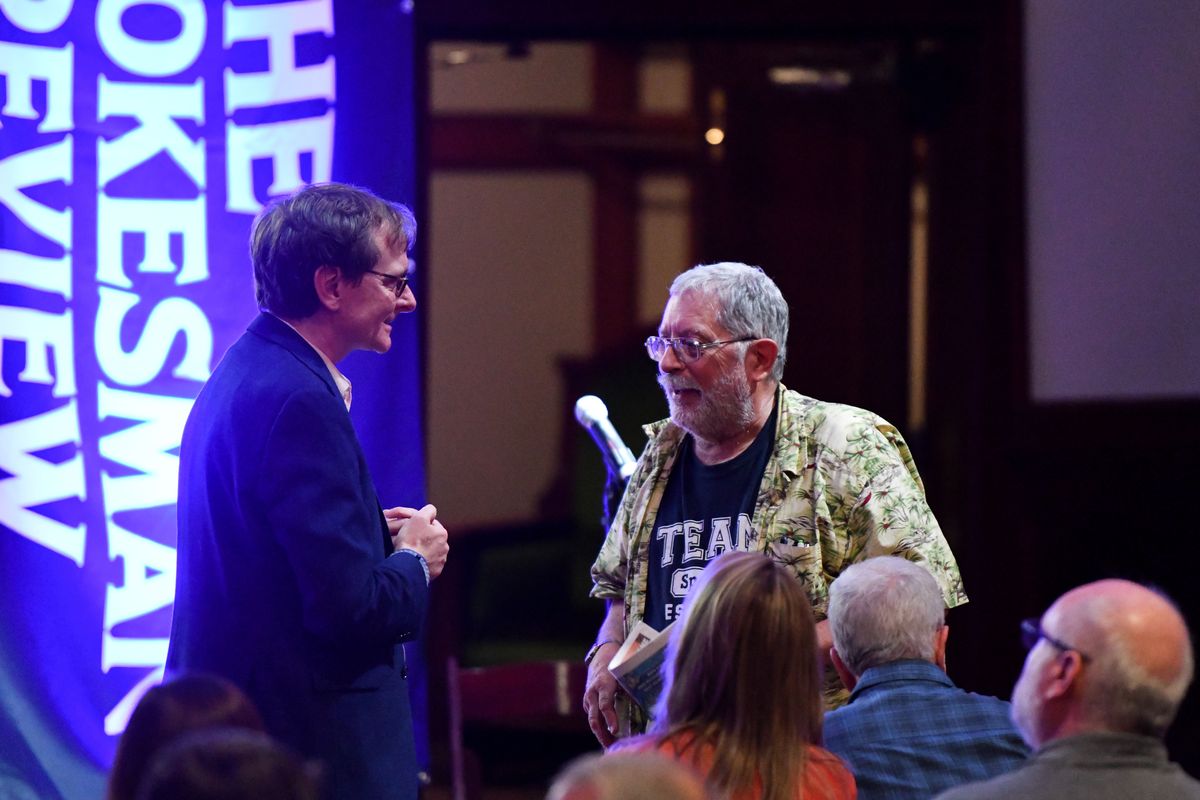 Spokesman-Review Editor Rob Curley chats with book club member Owen Mir during the Northwest Passages Book Club’s Summer Stories: Summer of ’69 edition on Aug. 14, 2019, at the Montvale Event Center in Spokane. Mir died July 28. He was 77. (Tyler Tjomsland/THE SPOKESMAN-REVIEW)