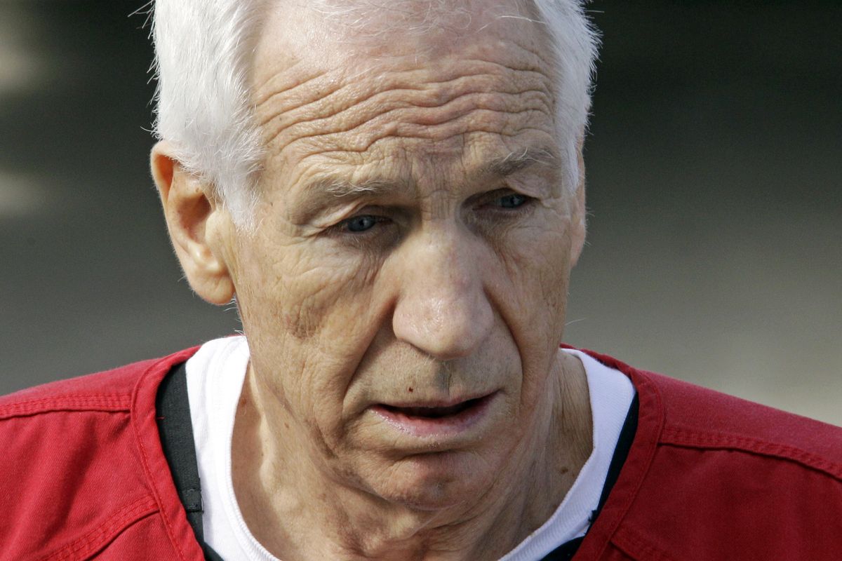 Former Penn State University assistant football coach Jerry Sandusky, center, leaves the Centre County Courthouse after being sentenced in Bellefonte, Pa., Tuesday, Oct. 9, 2012. Sandusky was sentenced Tuesday to at least 30 years in prison, effectively a life sentence, in the child sexual abuse scandal that brought shame to Penn State and led to coach Joe Paterno's downfall. (Gene Puskar / Associated Press)