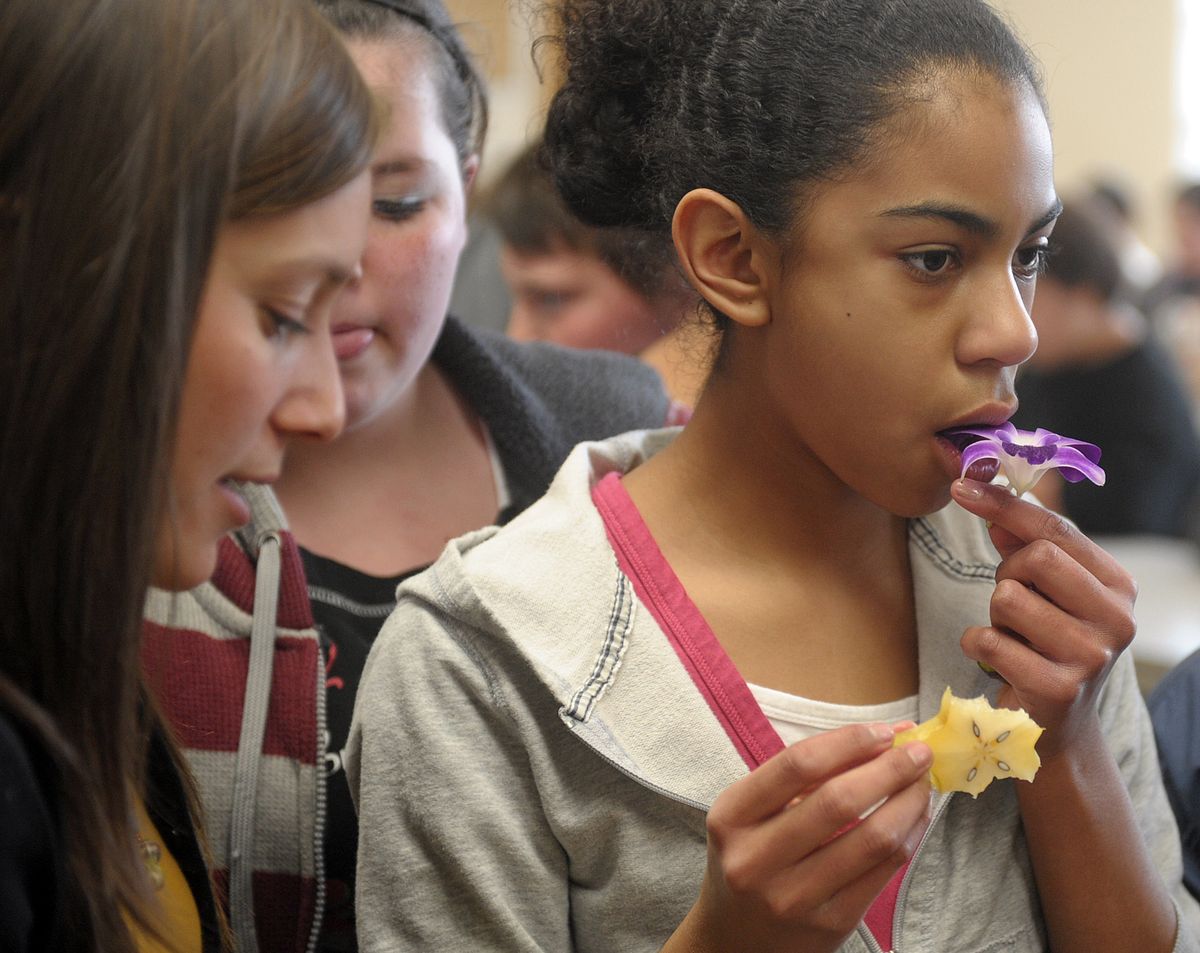 Shaw Middle School student, Chilli Gross, samples an edible flower during a lunch Food Fear Factor on Friday, April 9, 2010. (Christopher Anderson / The Spokesman-Review)