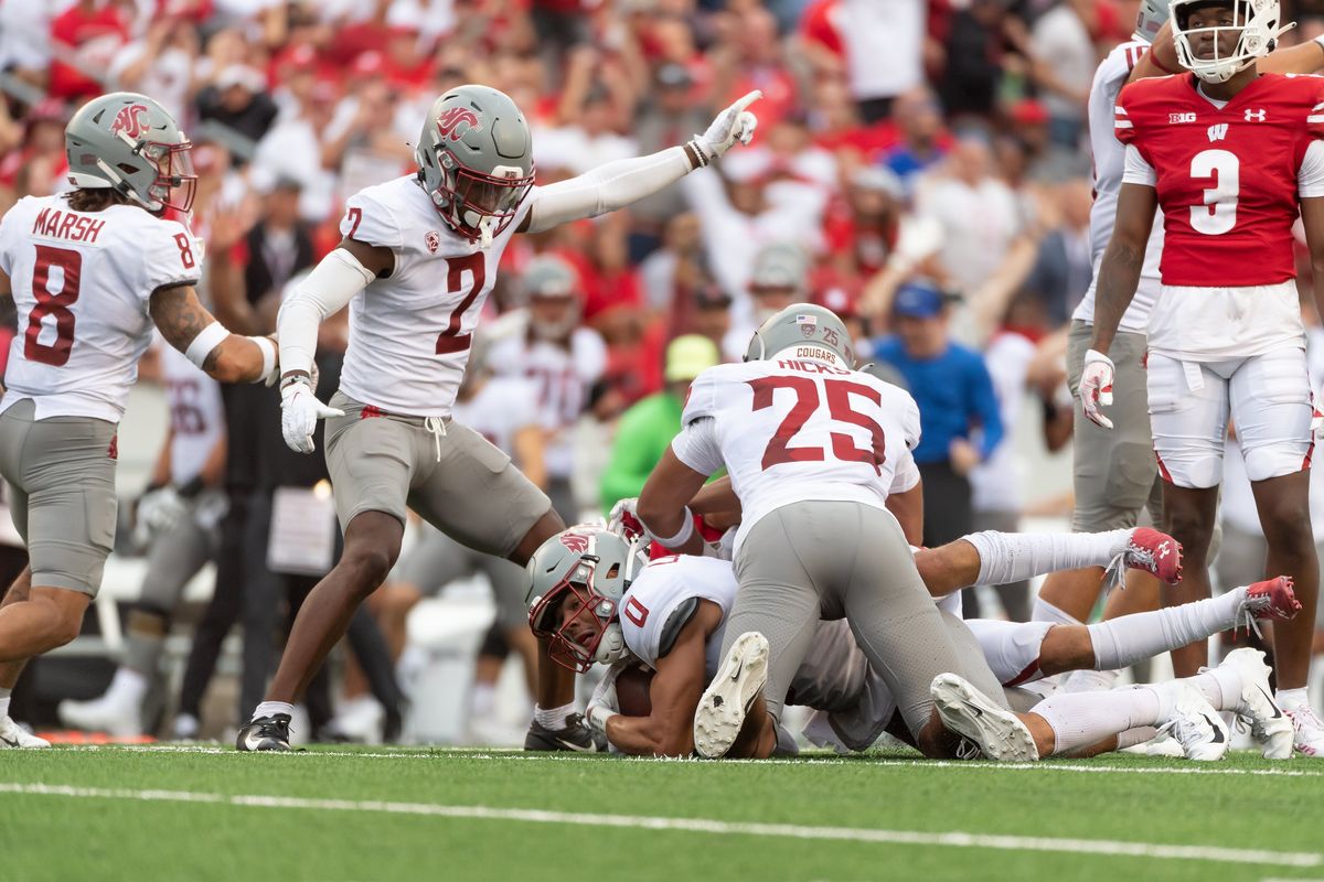 Washington State Cougars defensive back Sam Lockett III (0) recovers a fumble as Washington State Cougars defensive back Jaden Hicks (25), Washington State Cougars defensive back Chris Jackson (2), and Washington State Cougars defensive back Armani Marsh (8) indicate that Washington State the recovers during the fourth quarter at Camp Randall Stadium in Madison, WI on Saturday, September 10, 2022.   (Kirsten Schmitt/For The Spokesman-Review)