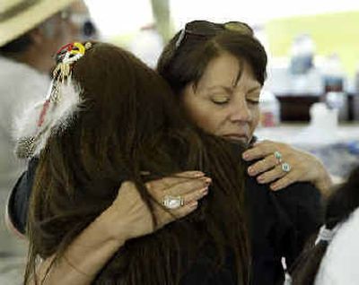 
Laura Wass, right, embraces Carla Foreman during a rally protesting the disenrollment of tribal members during a gathering of 16 tribes from across the United States held in Temecula, Calif., on Saturday. 
 (Associated Press / The Spokesman-Review)
