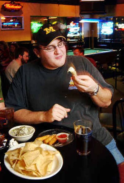 
Dave Champlin eats nachos at a restaurant in Columbia, Mo.
 (Associated Press / The Spokesman-Review)