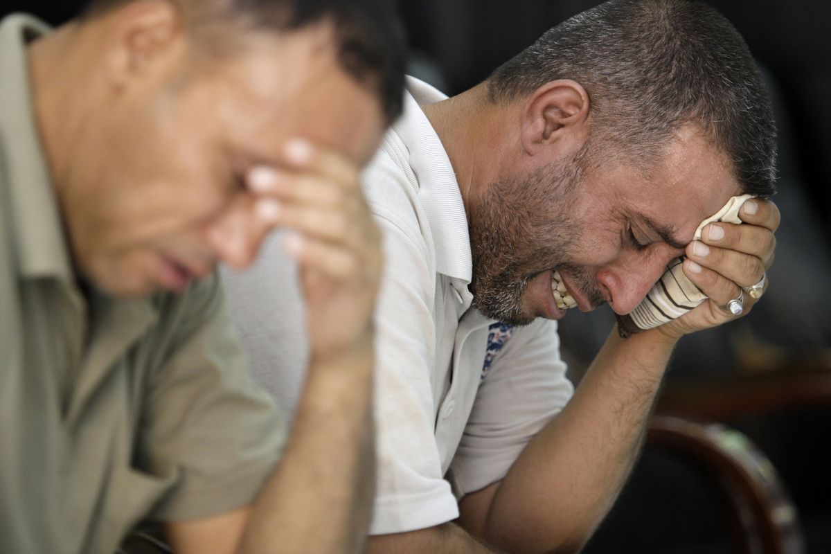 Followers of Abdul Aziz al-Hakim weep after the announcement of the Iraqi Shiite leader’s death Wednesday.  (Associated Press / The Spokesman-Review)