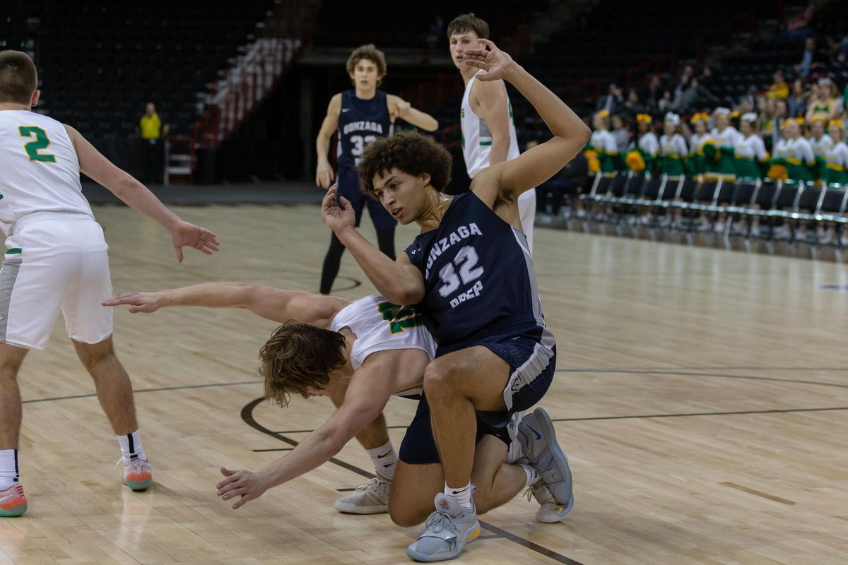 Anton Watson, right, gets tangled up with Cody Sanderson in Gonzaga Prep’s 64-47 win over Richland in the District 8 4A boys championship game at the Spokane Arena on Feb. 16, 2019. (Cheryl Nichols / For The Spokesman-Review)